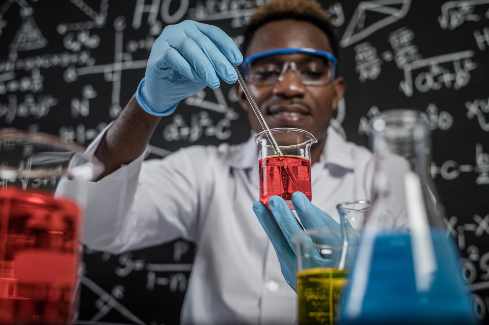 Scientists mixing red chemicals in glass at the laboratory. cantrust auto repair